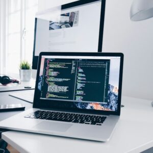 Laptop showing code on a desk